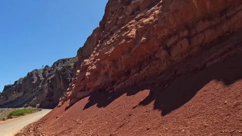 The red rocky hillside along which the road runs Video stock 317168513