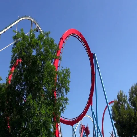 Red roller coaster half loop with a tree Vídeos de archivo 69734441