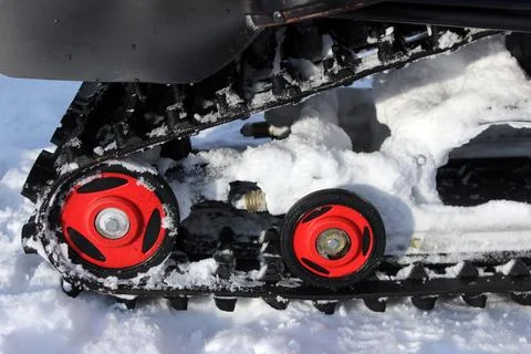 Red rollers of a snowmobile caterpillar Stock Photos