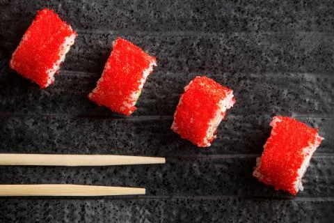 Red rolls on a dark plate Stock Photos
