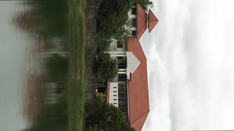 A red roofed house next to a large pond. Stock Footage 159943529