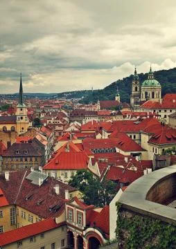 Red roofs under cloudy sky in prague. Stock Photos