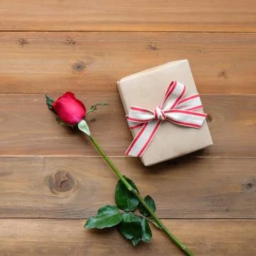 Red rose and vintage gift box on vintage wood background Stock Photos