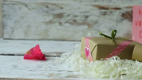 Red rose petals falling down on wooden table. 4k dolly shot Video stock 71362398