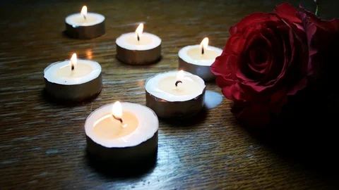 Red rose in the twilight surrounded by candles Video stock 123305686