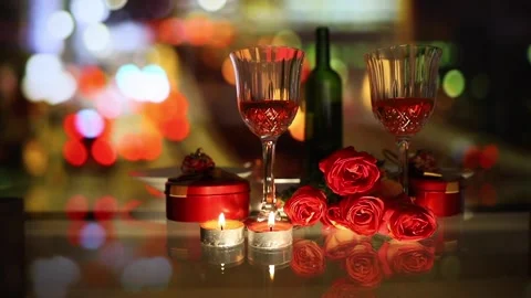 Red roses, candles in table setting with wine glass and bottle. blurred color Stock Footage 148362495