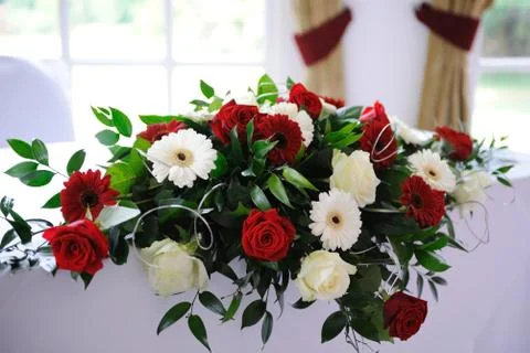 Red roses decorate table at wedding ceremony. Stock Photos