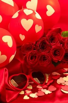Red roses in a gift box on red background with pink and white hearts scattered Stock Photos