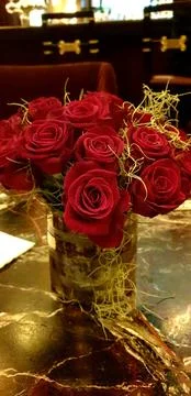 Red roses in vase on the table Stock Photos
