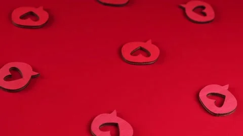 Red rotating background with decorative wooden hearts. concept of celebrating Stock Footage 167451058