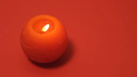 Red round burning candle isolated on red background. Full HD slow motion Stock Footage 174920925