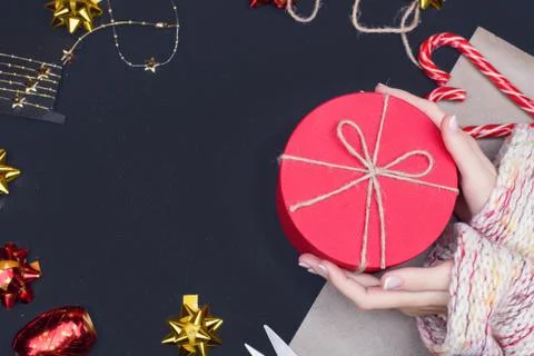 Red round gift box on black background, new year and Christmas gift wrapping Stock Photos