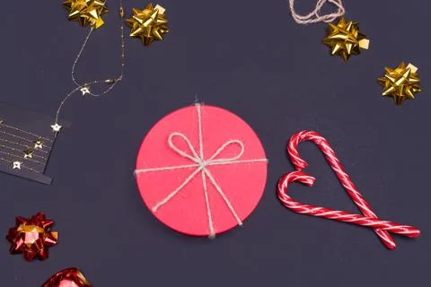 Red round gift box on black background, new year and Christmas gift wrapping Stock Photos