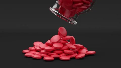 Red round tablets are poured out of a glass jar Stock Footage 161606608