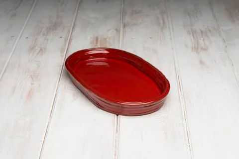 Red Rounded Rectangular Shallow Dish on White Wooden Panel Surface Stock Photos