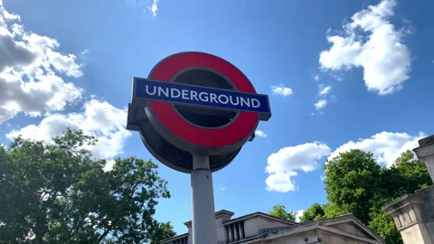 Red roundel sign of Piccadilly Circus underground station against blue sky Stock Footage 320297844
