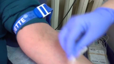 Red rubber heart in a hand. Man hand is donating venous blood. Gripping Stock Footage 130348441