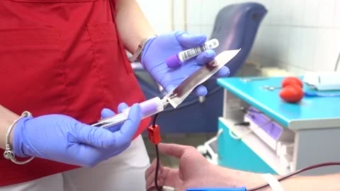 Red rubber heart in a hand. Man hand is donating venous blood. Gripping Stock Footage 130356985