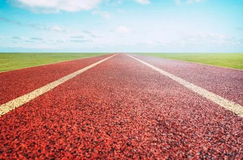 Red running track with sky background . Foto stock