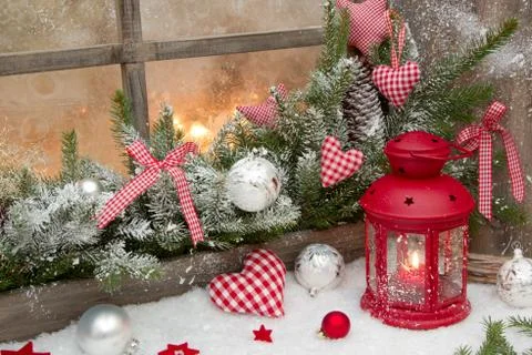 Red rustic christmas decoration on window sill with red checked hearts in cou Stock Photos