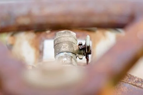 Red rusty pipe fitting of industrial water pump Stock Photos