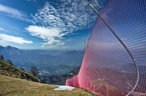 Red safety nets installed on ski slopes Stock Photos
