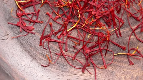 Red saffron threads on wooden surface Stock Footage 337413445