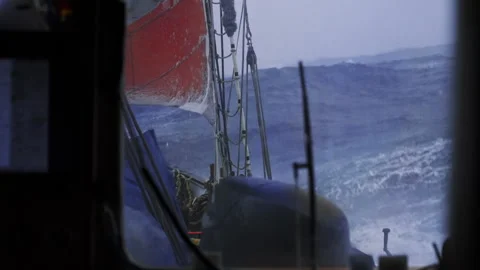Red Sail and Giant Storm Wave Outside Ship Cabin Stock Footage 337790320