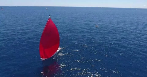 A red sailboat in the race Stock Footage 137644442