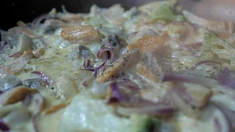 Red salmon fish, violet onion, broccoli is frying with creamy sauce on the pan. Stock Footage 132770105