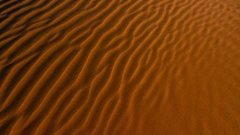 Red sand background with shadows from sunset sun, shot in desert at summer Foto stock