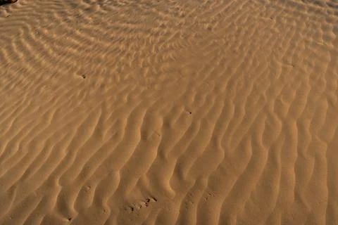 Red sand background with shadows from sunset sun, shot in desert at summer Stock Photos