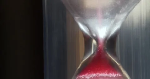Red sand in hourglass. Time flows backwards, in opposite direction Video stock 270554479