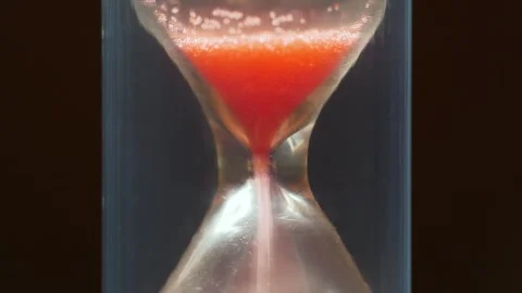 Red sand in hourglass. Time flows backwards. Time works wonders,cures all things Stock Footage 274651087