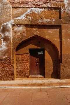 Red sand stone brick wall and wooden door Stock Photos