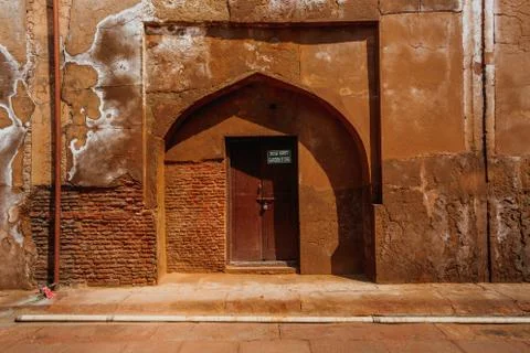 Red sand stone brick wall and wooden door Stock Photos