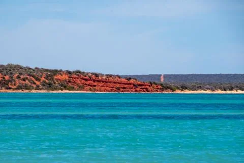 Red sand stone cliffs at the beach of Shark Bay Australia Stock Photos