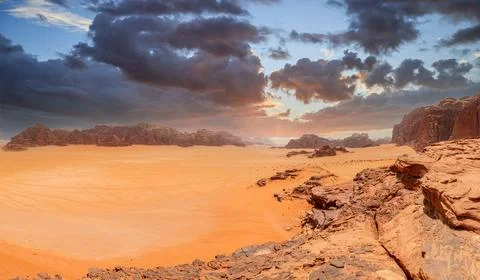 Red sands, mountains, dramatic sky and marthian landscape panorama of Wadi .. Stock Photos