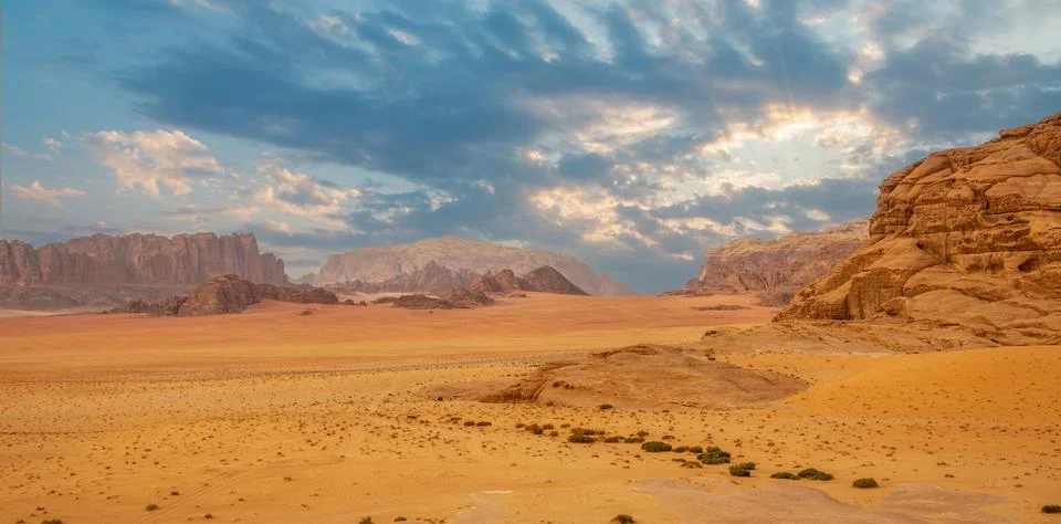 Red sands, mountains, dramatic sky and marthian landscape panorama of Wadi .. Stock Photos