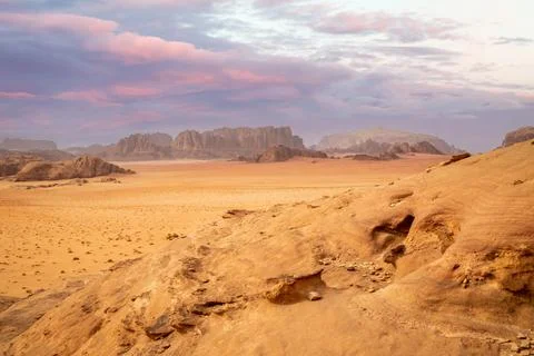 Red sands, mountains, dramatic sky and marthian landscape panorama of Wadi .. Stock Photos