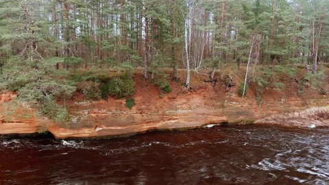 Red sandstone cliffs in the banks of river Salaca, Latvia 스톡 동영상 146060748