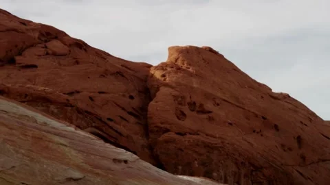 Red sandstone cliffs rise under a vast blue sky Stock Footage 329558317