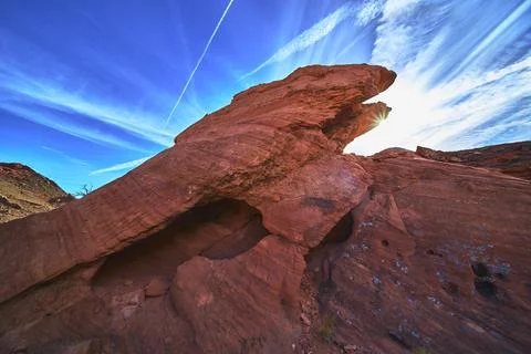 Red Sandstone Eagle Formation Sunburst and Dramatic Sky in Nevada Desert La.. Stock Photos