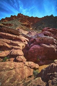 Red Sandstone Formations and Dramatic Cliffs Under Vibrant Blue Sky in Neva.. Stock Photos