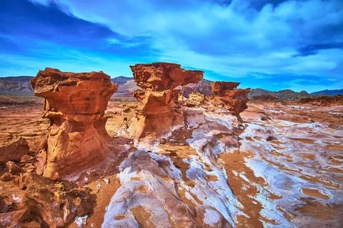Red Sandstone Formations and Eroded Landscape Under Dramatic Blue Sky in Dese Stock Photos