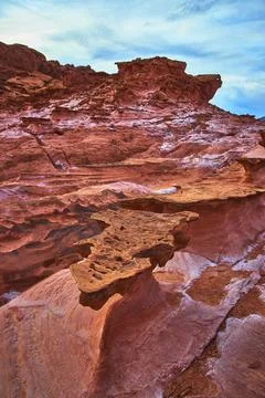 Red Sandstone Formations and Eroded Ledges in Dramatic Desert Landscape Nevad Stock Photos