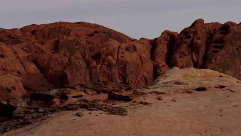 Red sandstone rock formations pan across a desert landscape Video stock 329558043