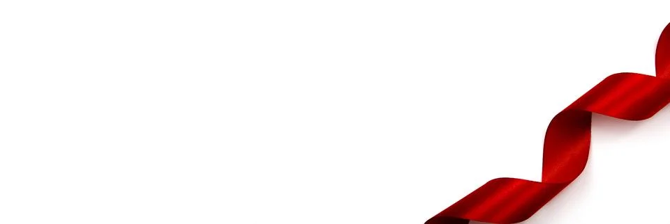 Red satin ribbon on a white background. Copy space. Stock Photos