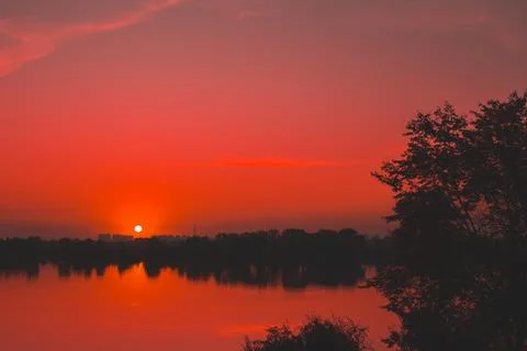 Red saturated sunset on the river Stock Photos