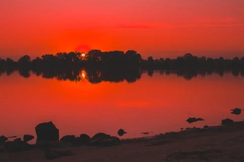 Red saturated sunset on the river Stock-Fotos